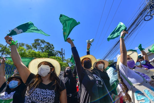 Women hold up flags during an abortions rights protest.