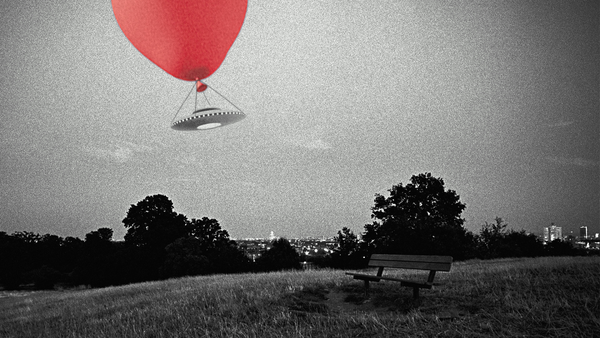 A faked photo of a UFO with a red balloon attached to it over a park