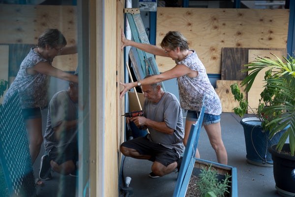 Frederic Herodet and Mary Herodet board up their Gulf Bistro restaurant in St Petersburg Beach, Florida