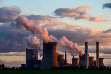 Smoke from chimneys of Coal powered plants w pink sky