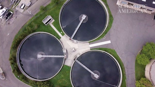 Three large circular tanks containing liquid are seen from a vantage point above them in the sky