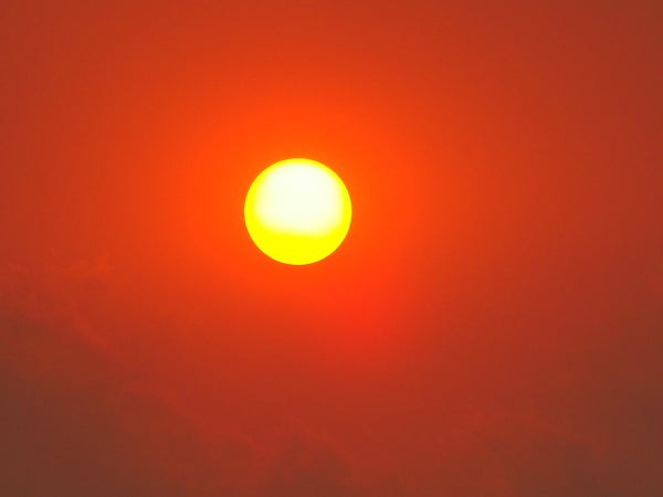 Yellow sun in red smoke.