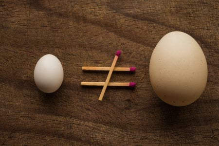 Directly Above Shot Of Matchsticks Formed In Mathematics Symbol Amidst Eggs On Wooden Table