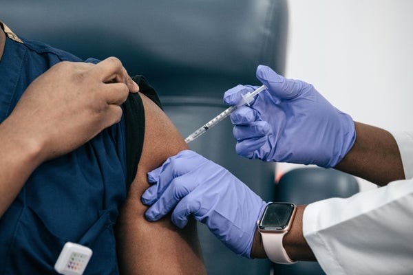 Healthcare worker gives patient a shot