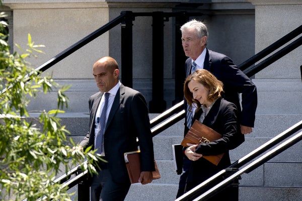 Rostin Behnam, Jerome Powell and Jelena McWilliams (left to right) walking toward the West Wing of the White House.