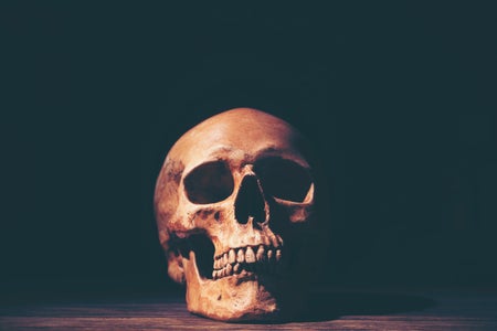 Close-Up Of Human Skull Against Black Background