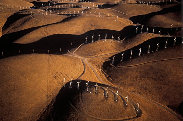 Aerial shot of wind turbines on hilly landscape