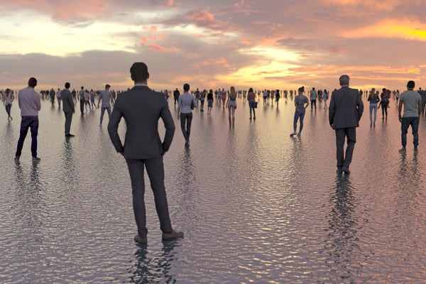 Human silhouettes on a background of a sunset on a calm sea.