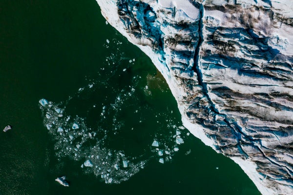 Aerial shows bergy bits and growlers floating in front of the Apusiajik glacier.