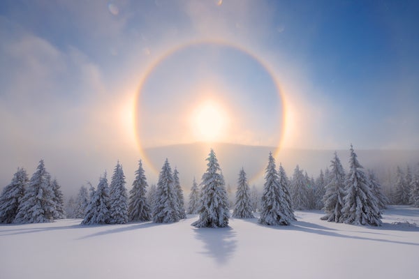 Halo (Icebow or gloriole) around sun with winter landscape