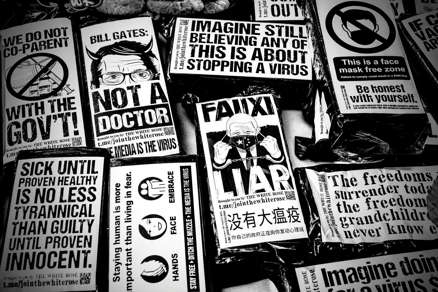 A table of T-shirts with antimask slogans.