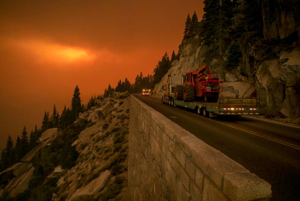 Glowing fire behind highway.