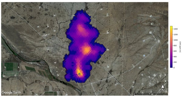 An aerial view of a purple/orange methane plume with landscape.
