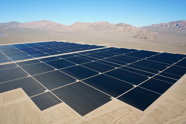A large field of solar panels in the Mojave Desert, California.