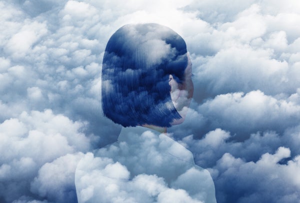 Double exposure of woman looking in to clouds