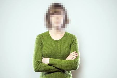 A woman with her face pixellated to make it unrecognizable.