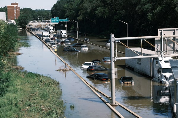 Abandoned cars and trucks on a flooded highway.