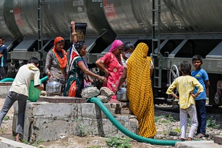 Women filling their pitchers with water