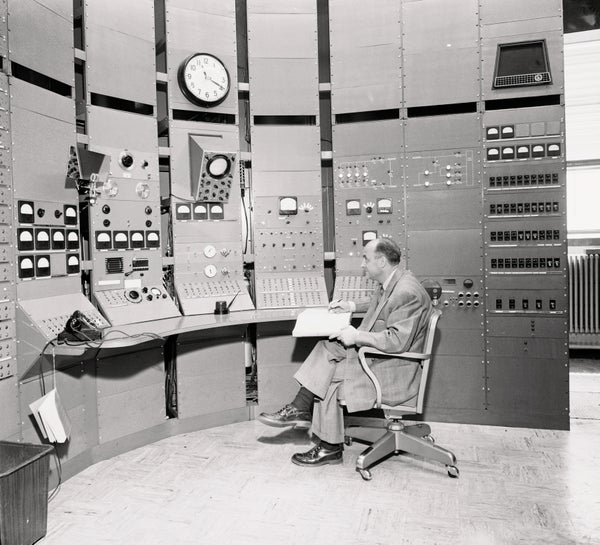 Dr. Enrico Fermi sits in control room of the synchro-cyclotron.