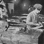 Airplane manufacture relied on skilled carpentry. Here, women workers in a British factory, 1917. Note the brace-and-bit drill and other hand tools on the bench.
