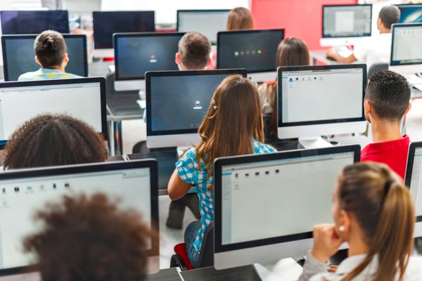 Classroom of college students sitting in front of desktops