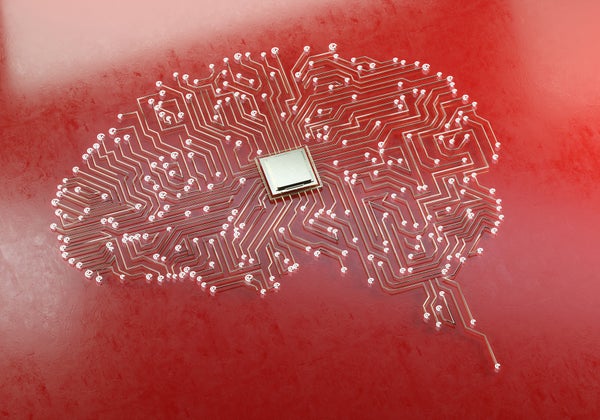Computer circuits that form the shape of a brain, with a chip in the middle.