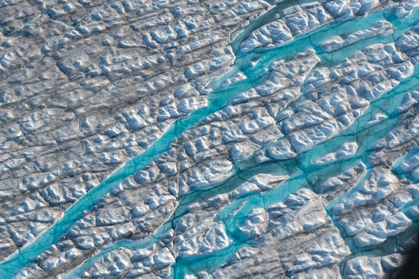 Aerial of three meltwater rivers carving into the Greenland ice sheet.