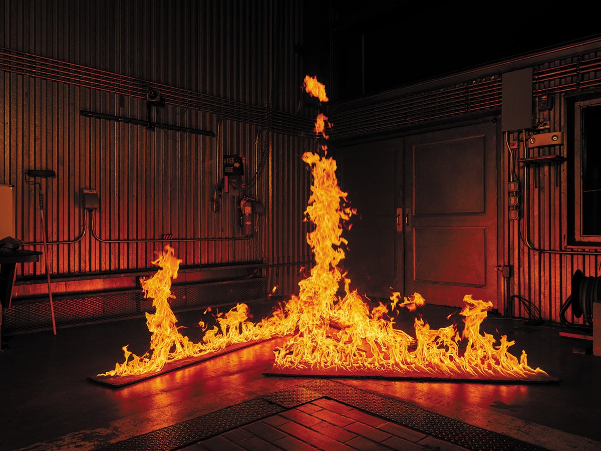 Burning boards arranged in a rough triangle allow air to swirl into the central area