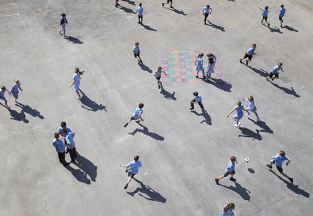 Children aged 10-11 running on playground elevated view