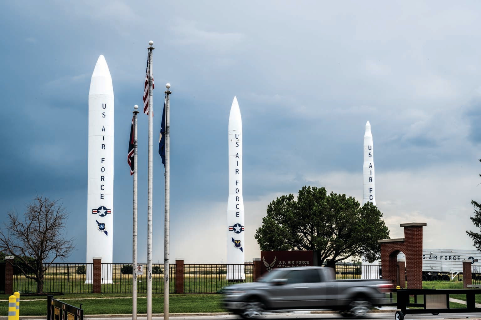 Three missiles shown on display on a lawn.